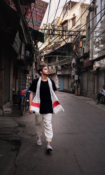 The  guy wearing authentic indian style clothes roaming in streets of old delhi india