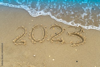 The numbers 2023 are written on a sandy seashell beach. Wave and surf. Summer New Year. Vacation, resort and recreation. Nature. Sea coast