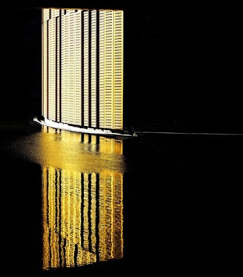 The reflection of a brightly lit wall on the water surface at Fiera Milano Rho P5.