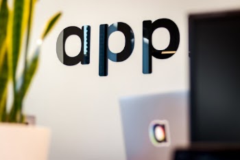 The typical App start-up with their name on the wall.