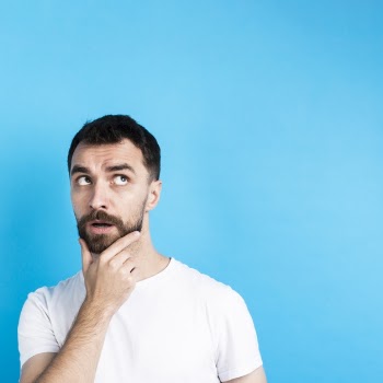 Thinking man posing with hand on chin Free Photo