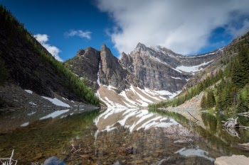 This is Lake Agnes, which can be found by doing any of the Little Beehive, Big Beehive or Lake Agnes trails when you arrive at Lake Louise, Banff. We had a bit of a varied day weather wise, so I set my camera & tripod up on a small bridge and just waited until the wind died down to get this reflection. There's also an awesome Tea House right next to it, however they only take cash so I missed out on some of their famous chocolate cake this time... but next time ;)