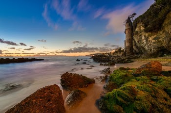 This photo is taken after the sunset when most of the other photographers have left this popular spot in Laguna Beach. Finally there are no more people in the frame and the lights from the far away added more color to the picture. 