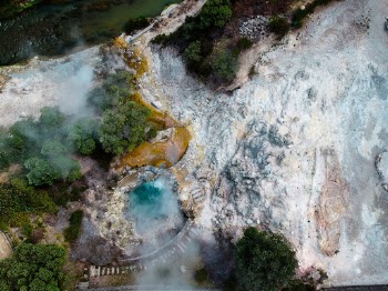 This photo was taken in Furnas, São Miguel. This area is knows for its geothermal activity, the village center is full of holes with boiling water and if you touch the ground everything is warm.

On top of that the colors of the earth make you feel like you're in another world.