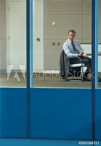 Thoughtful businessman looking out office window
