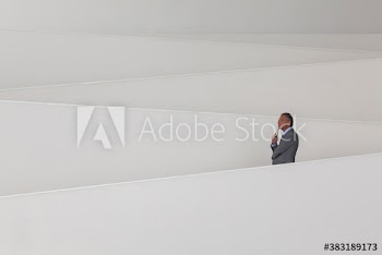 Thoughtful businessman on modern office ramp
