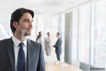 Thoughtful corporate businessman in office