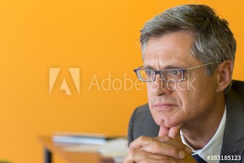 Thoughtful mature businessman looking away