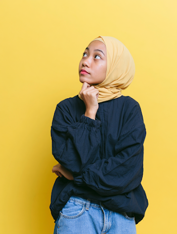 Thoughtful Young Southeast Asian Woman in Hijab