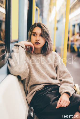 Thoughtful young woman traveling in subway train