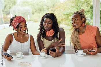 Three African American best friends using smartphones, concept of Hipster millennials girls having fun at coffee shop and using dating app