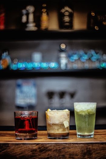 three assorted cocktails on table