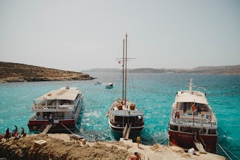 Three Assorted-color Boats in Body of Water