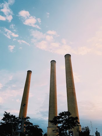 Three Beige Towers Under White Clouds