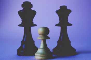 Three Black and Beige Chess Pieces