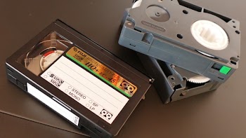 Three Black Vhs Cases on Black Surface