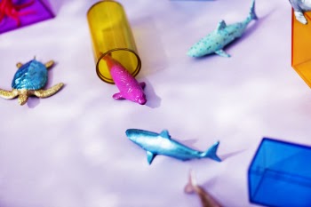 Three Blue and Pink Fish and Blue and Brown Turtle Figurine on White Textile