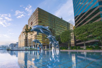 Three Blue Dolphins Statue Front of Water Near Building