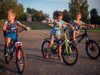 Three Boys Riding Their Bikes