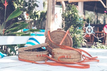 Three Brown Cross-body Bags on Table