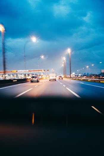 Three Cars Traveling on Road