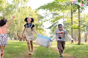 Three Children Playing Near Trees