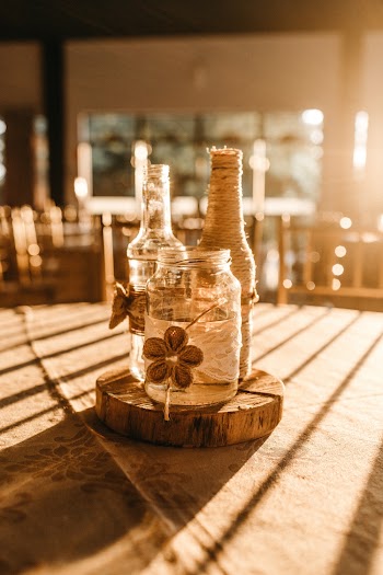 Three Clear Glass Bottles on Brown Slab
