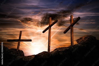 Three crosses on a dramatic sky at sunset