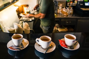 Three Cups of Coffee on Saucers