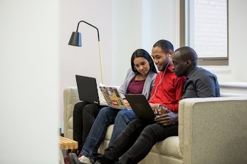 Three Friends Working On Couch