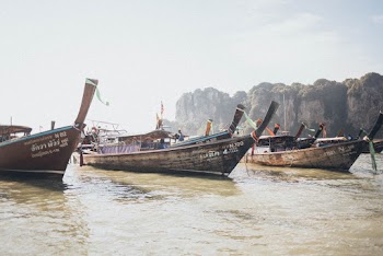 Three Gray Boats on Water