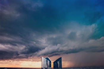 three high-rise buildings under dark sky