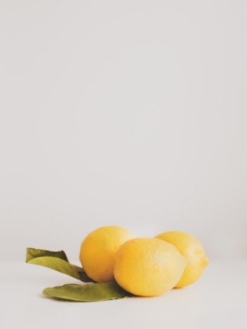 Three Lemons on White Surface