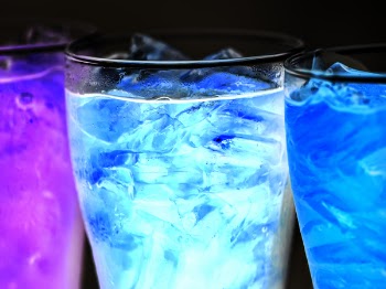 Three Lighted Cocktails Inside Drinking Glasses