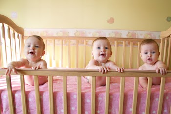 Three Little Baby Girls in Crib