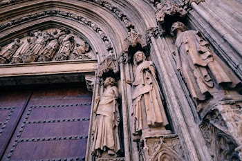 Three Male Carvings on Arch