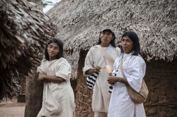 Three Man Standing Near Hut