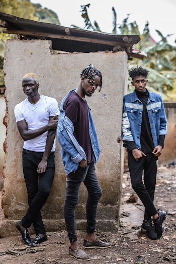 Three Man Standing Near Shed