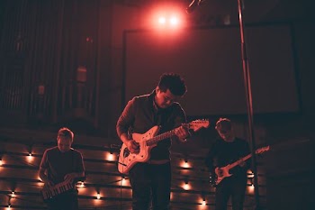three men playing instrument