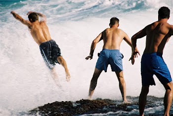 Three Men Playing Surfboards