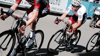 three men racing bicycles