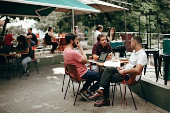 Three Men Sitting at the Table