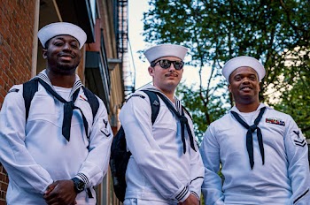 Three Men Standing in White Uniform and Smiling