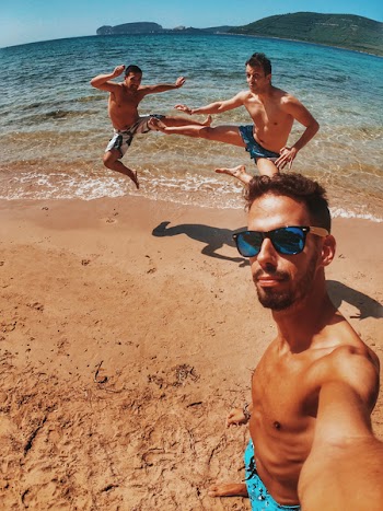 Three Men Standing On Beach Shore