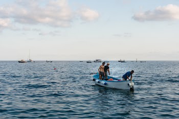 Three Men Standing on Boat