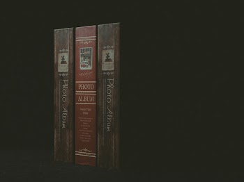 Three Paperback Books on Black Surface