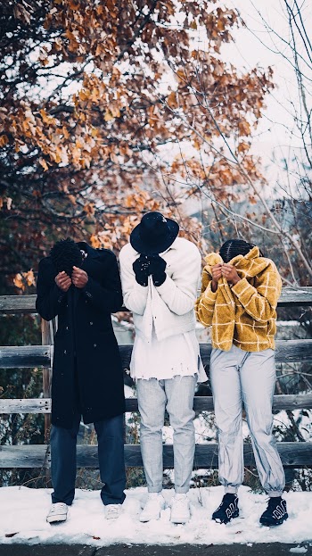 Three People Covering Their Faces