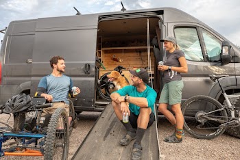 Three People Having a Conversation While Drinking Beer