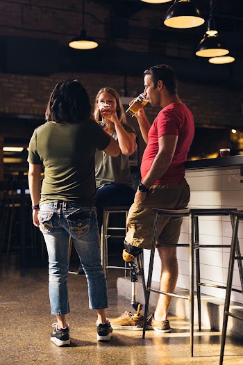 Three People Holding Drinking glasses 