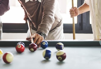 Three People Playing Billiards